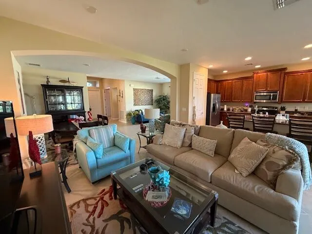a bedroom with furniture and a large window