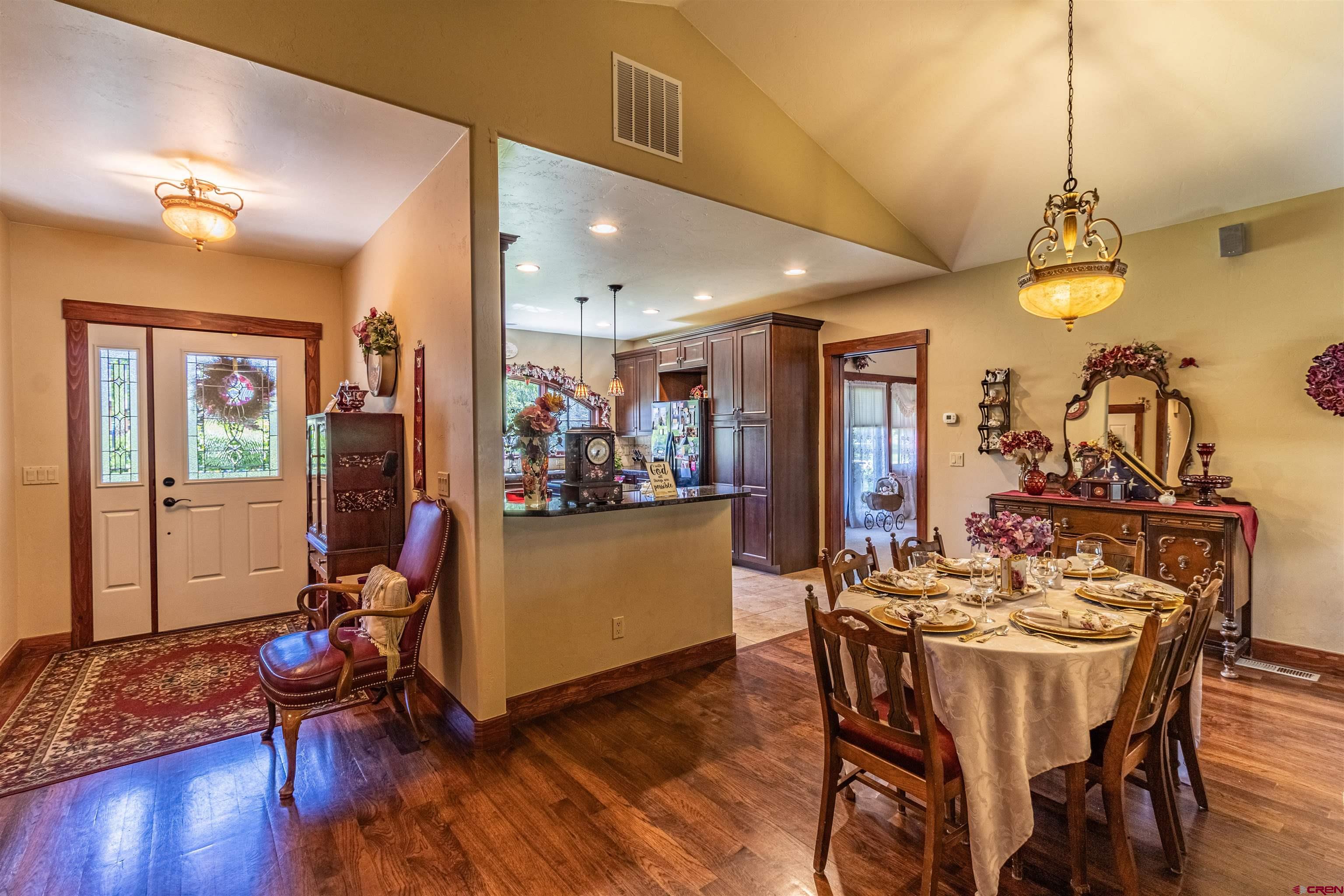 1167 North Dalton Ranch Road Durango, CO 81301 - Photo 6 of 45 a view of a dining room with furniture and wooden floor