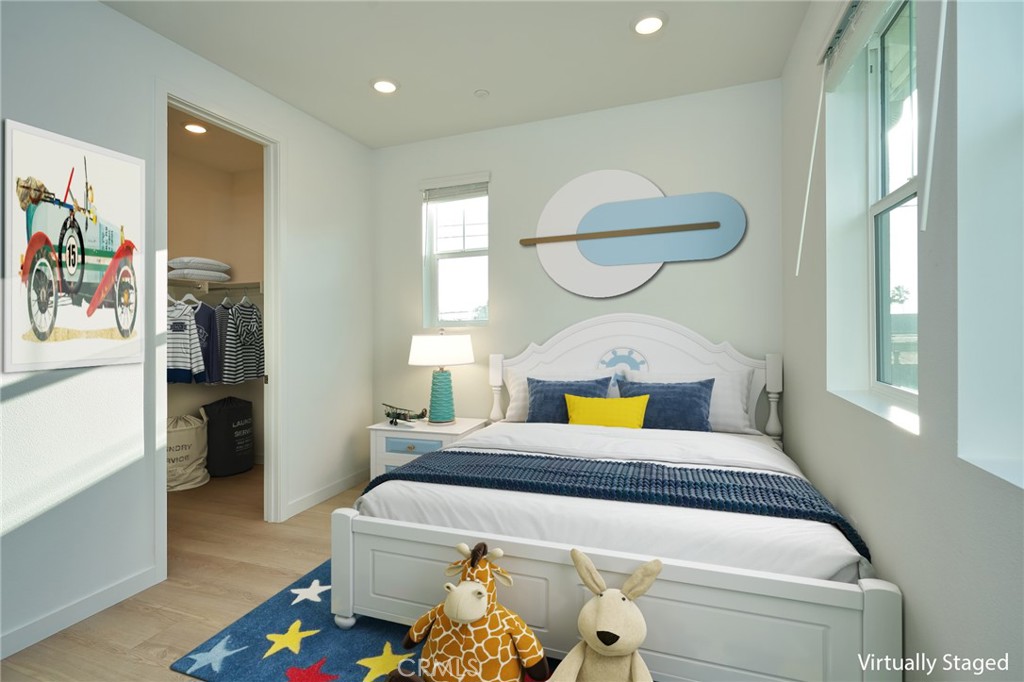 2448 Haley Pt Drive, Unit 105 Ventura, CA 93003 - Photo 11 of 27 a bedroom with a bed and a chandelier