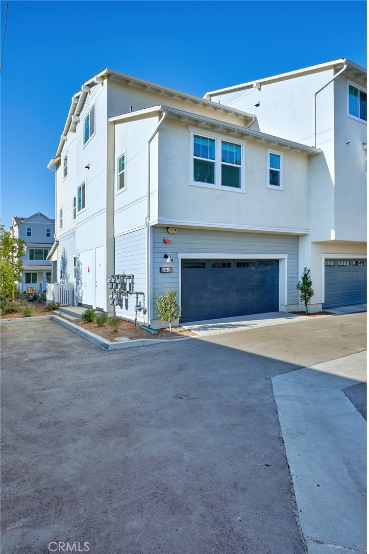 2448 Haley Pt Drive, Unit 105 Ventura, CA 93003 - Photo 20 of 27 a front view of a house with a yard