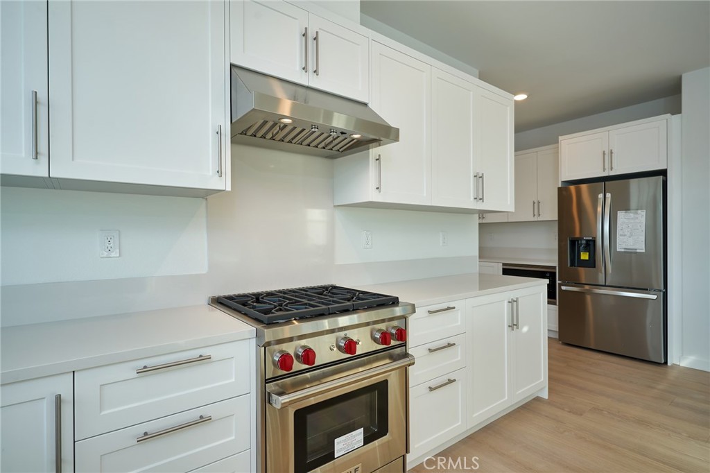 2448 Haley Pt Drive, Unit 105 Ventura, CA 93003 - Photo 3 of 27 a kitchen with stainless steel appliances a stove and a refrigerator