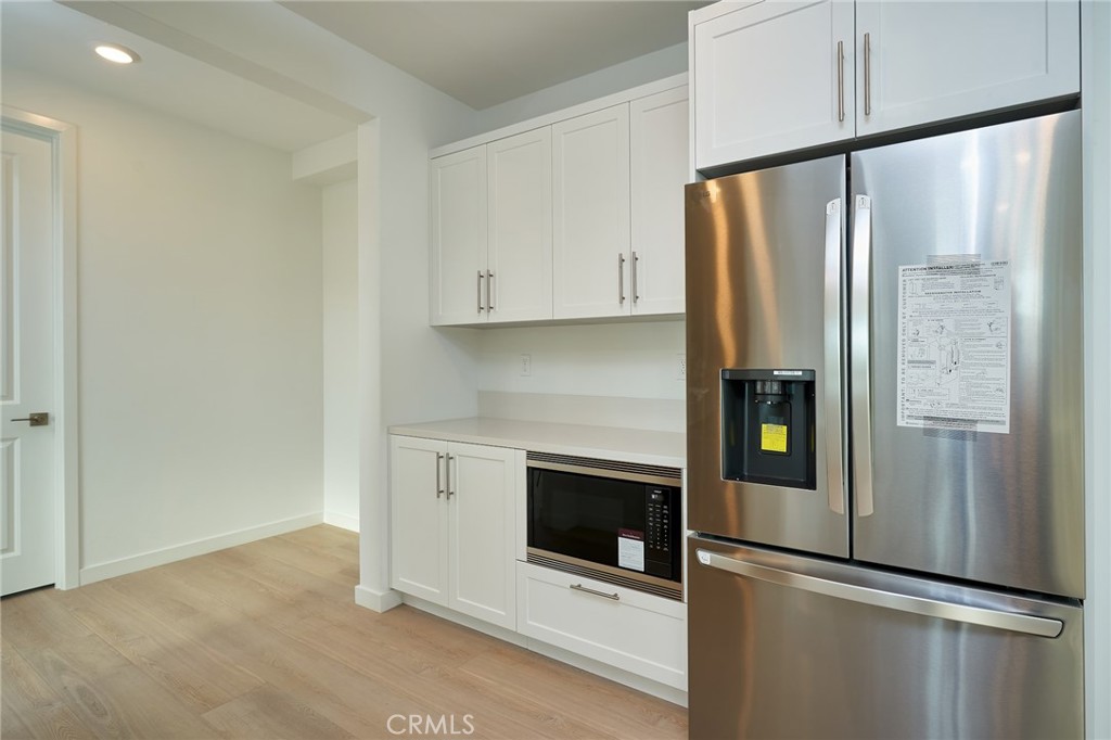 2448 Haley Pt Drive, Unit 105 Ventura, CA 93003 - Photo 4 of 27 a kitchen with stainless steel appliances a refrigerator and a stove top oven