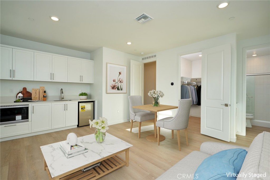 2448 Haley Pt Drive, Unit 105 Ventura, CA 93003 - Photo 7 of 27 a living room with furniture and wooden floor