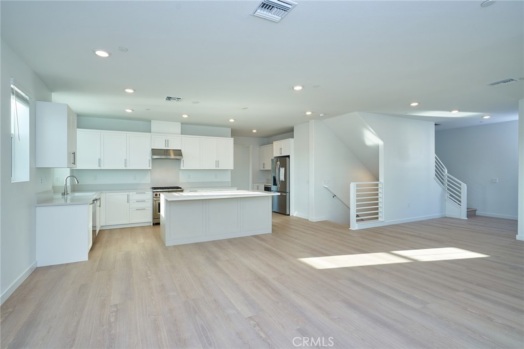 2448 Haley Pt Drive, Unit 105 Ventura, CA 93003 - Photo 10 of 27 a large kitchen with stainless steel appliances granite countertop a large counter top a sink and a stove