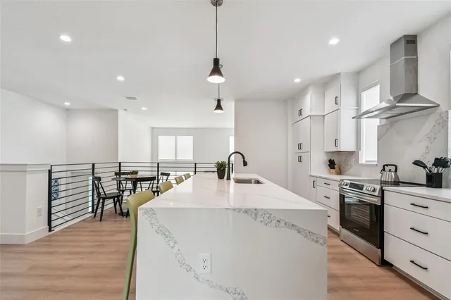 a view of a hallway a room with wooden floor and staircase