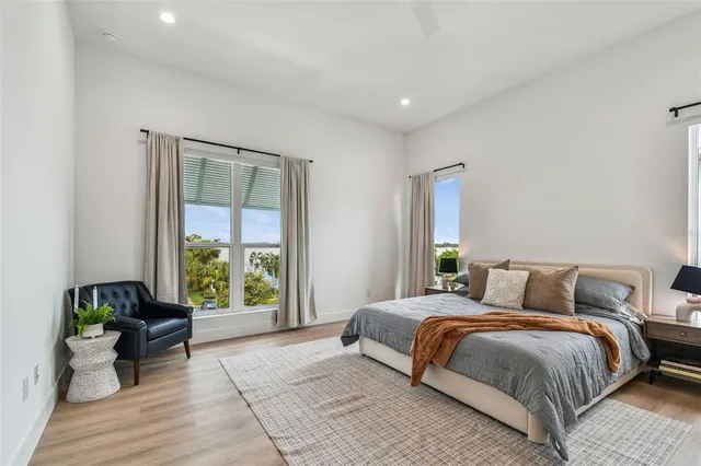 a bedroom with a bed and wooden floor