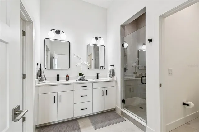 a bedroom with a bed and a lamp with wooden floor