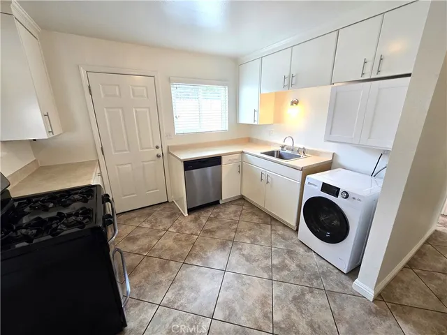a kitchen with a stove a sink and a refrigerator