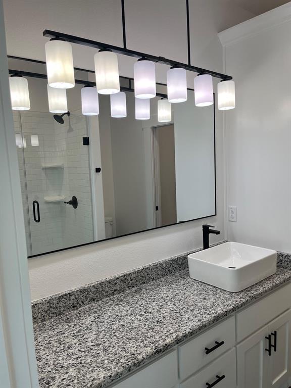 512 East Gandy Street Denison, TX 75021 - Photo 11 of 11 Full bath featuring vanity and a shower stall