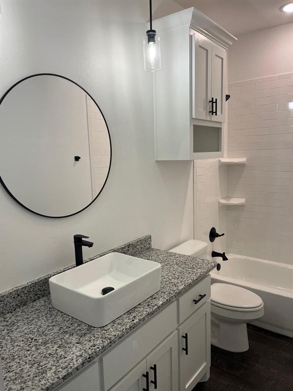 512 East Gandy Street Denison, TX 75021 - Photo 9 of 11 Full bath featuring vanity, shower / bath combination, and dark wood-type flooring