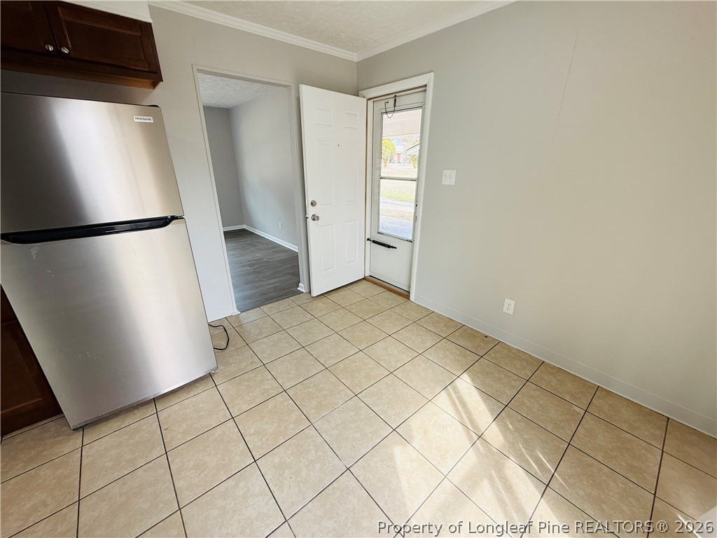4736 Rosehill Road Fayetteville, NC 28311 - Photo 6 of 15 a view of a refrigerator in kitchen and an empty room