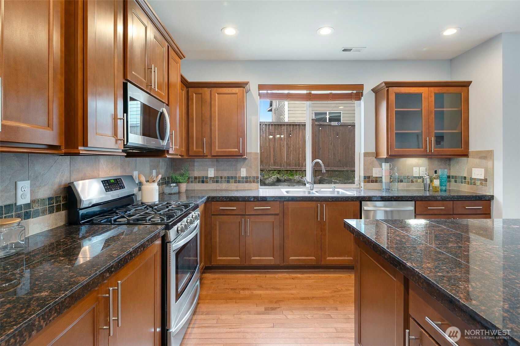 3931 177th Street Southeast Bothell, WA 98012 - Photo 12 of 39 a kitchen with stainless steel appliances granite countertop a stove a sink and a granite counter tops