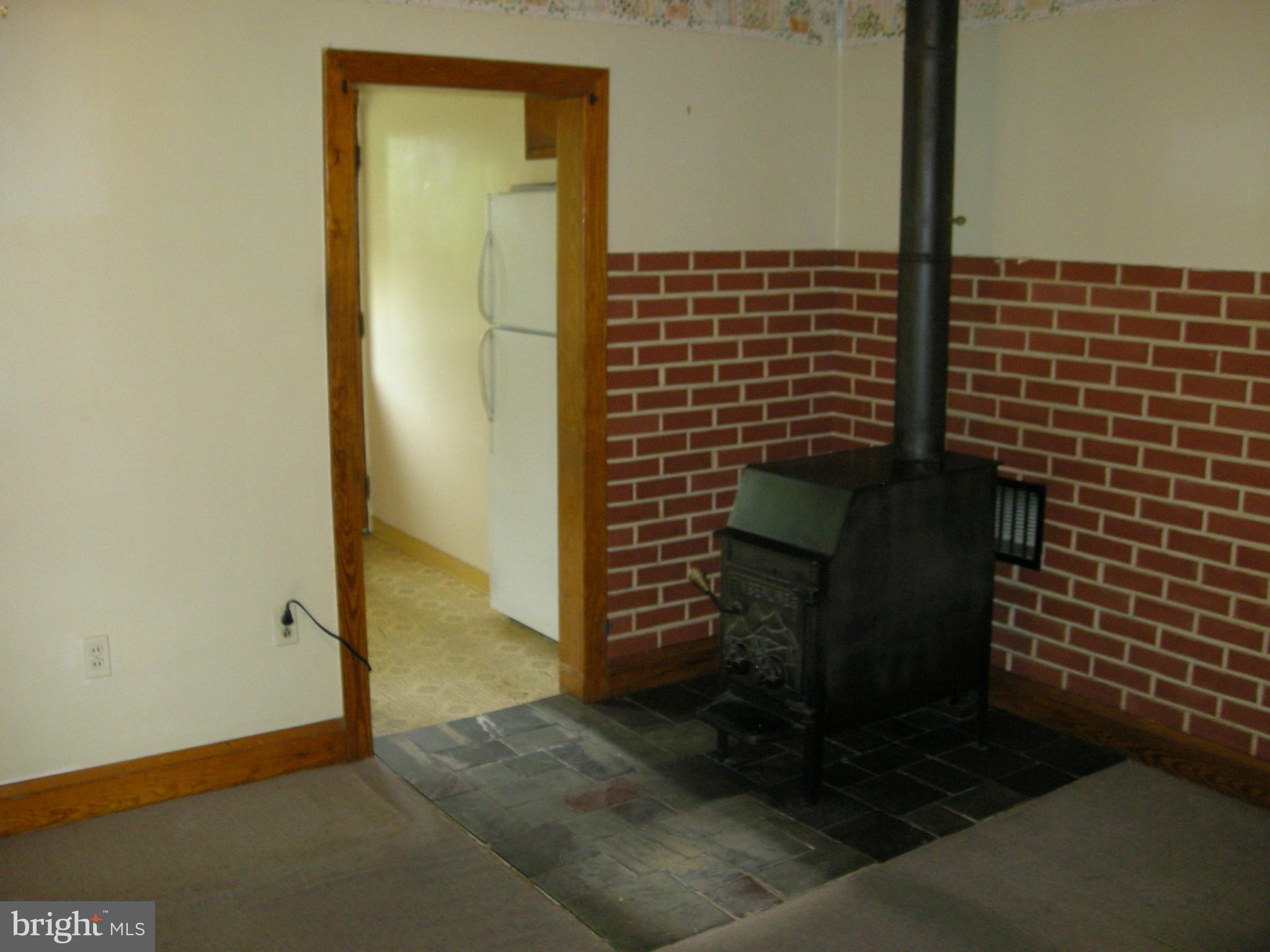 7901 33rd Street Rosedale, MD 21237 - Photo 11 of 14 Dining Room and woodstove