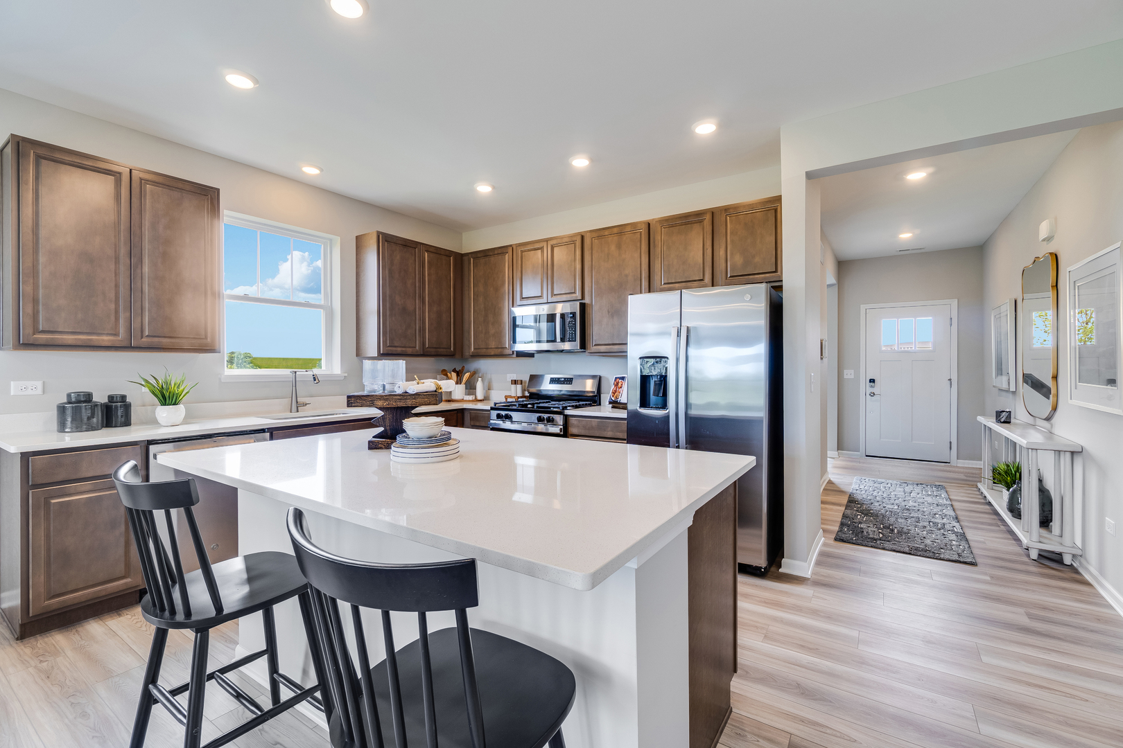 12231 Barcroft Circle Huntley, IL 60142 - Photo 14 of 38 a large kitchen with kitchen island a table and chairs