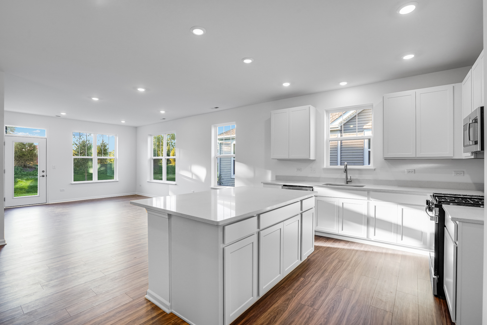 12231 Barcroft Circle Huntley, IL 60142 - Photo 3 of 38 a kitchen with a sink stove and cabinets
