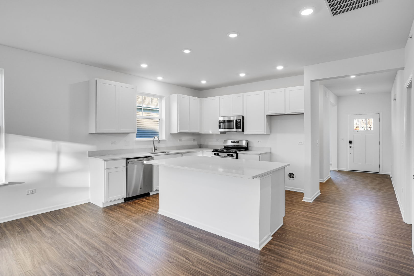 12231 Barcroft Circle Huntley, IL 60142 - Photo 4 of 38 a kitchen with stainless steel appliances a refrigerator sink and cabinets