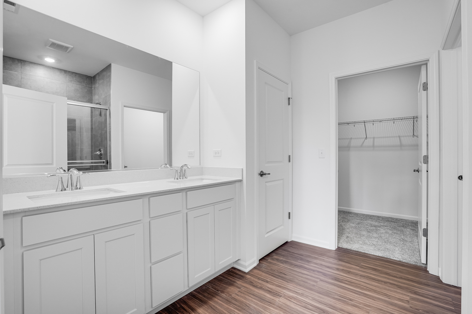 12231 Barcroft Circle Huntley, IL 60142 - Photo 7 of 38 a bathroom with a double vanity sink and mirror