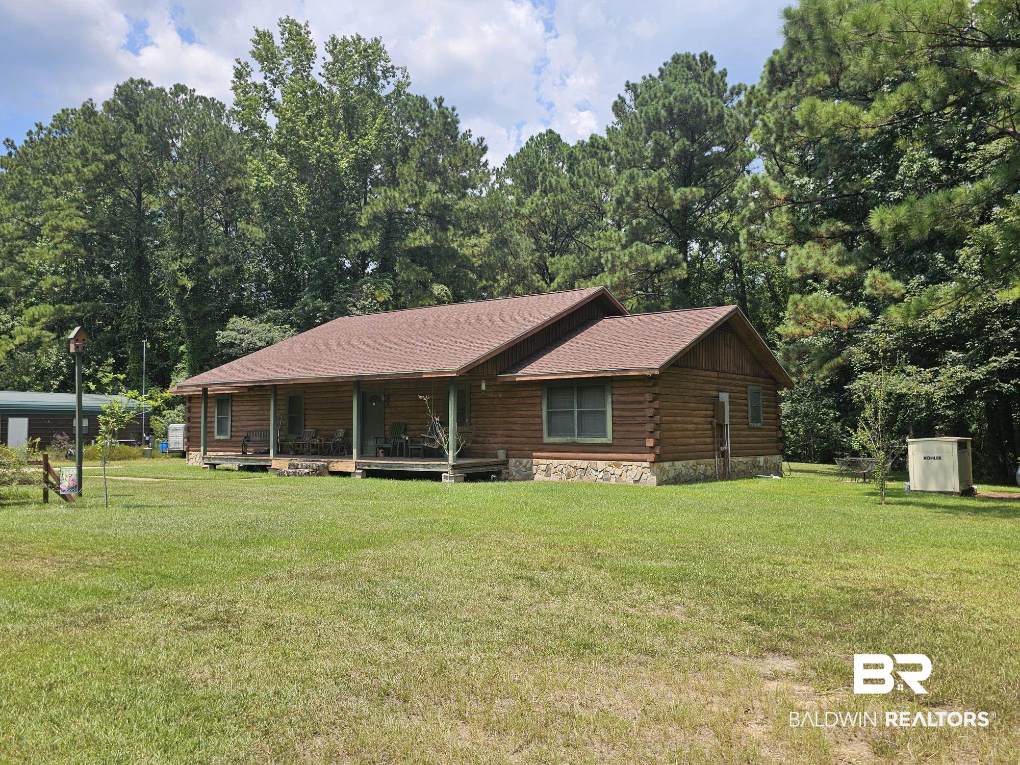 190 Magnolia Court Axis, AL 36505 - Photo 1 of 28 Log-style house featuring a shed and a front lawn