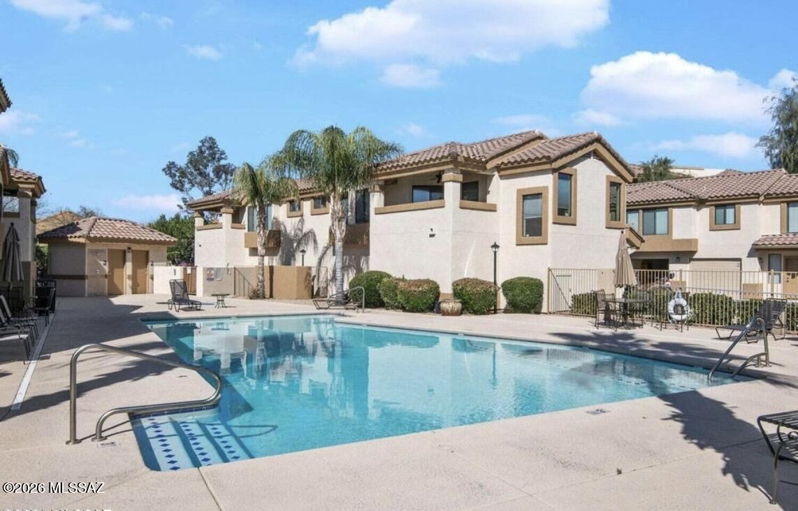 2550 East River Road, Unit 4204 Tucson, AZ 85718 - Photo 32 of 36 a view of a house with pool and chairs