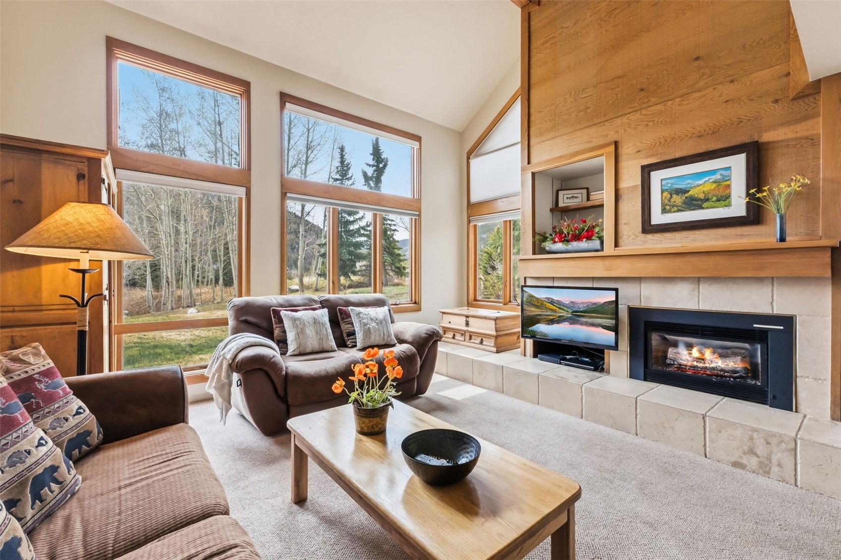 30 Tennis Club Road, Unit 1608 Keystone, CO 80435 - Photo 2 of 29 a living room with furniture a fireplace and a table