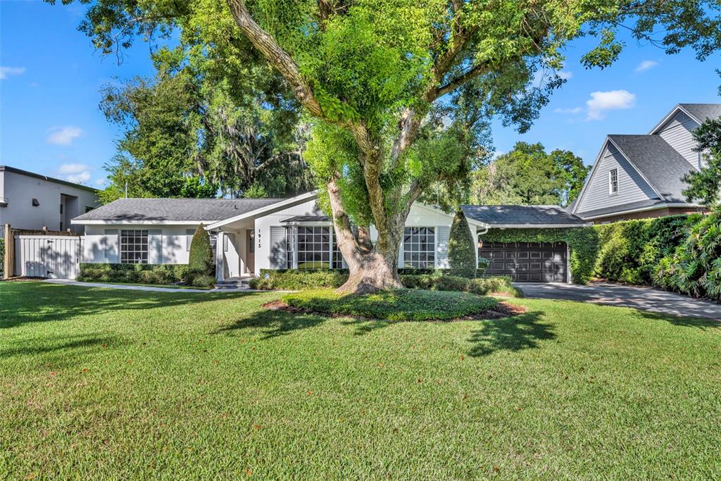 1915 Stonehurst Road Winter Park, FL 32789 - Photo 1 of 1 a front view of a house with a garden