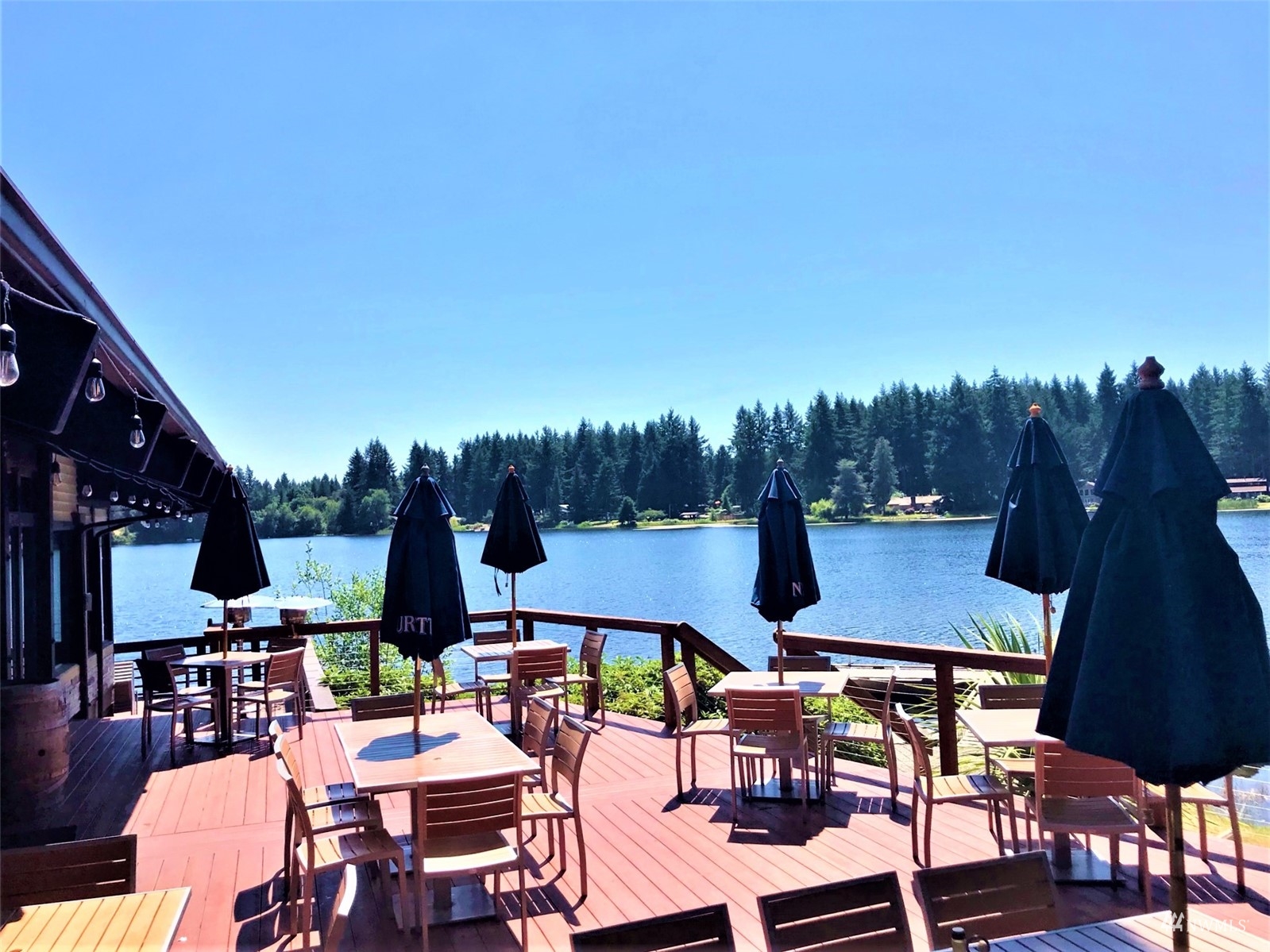 9024 Johnson Road Anderson Island, WA 98303 - Photo 11 of 18 a view of a patio with table and chairs and potted plants