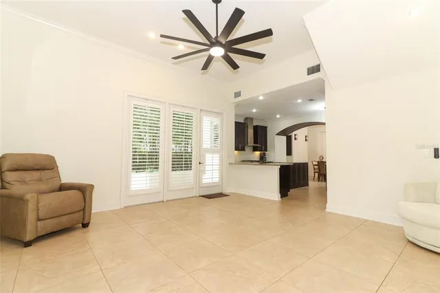 an empty room with a window and a ceiling fan