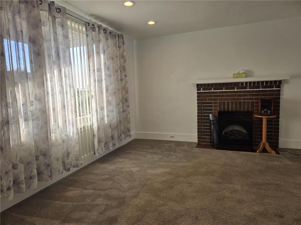 133 Freeport Road Butler, PA 16002 - Photo 14 of 26 a view of an empty room with a fireplace and a window