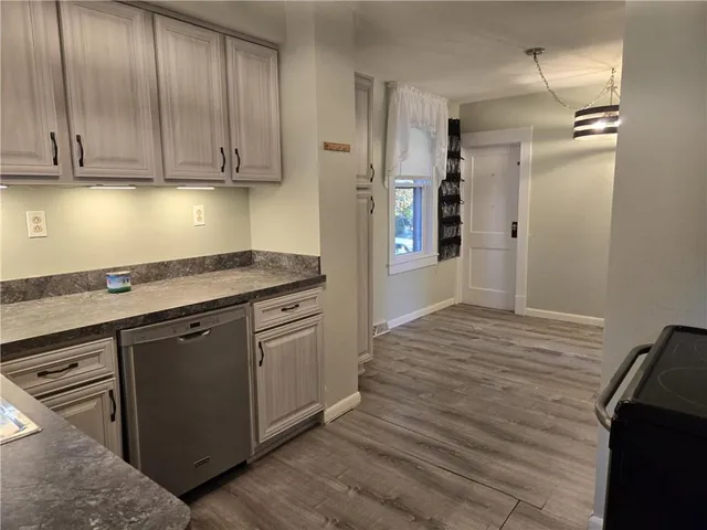 a kitchen with stainless steel appliances granite countertop a refrigerator and a stove top oven