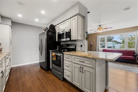 a kitchen with stainless steel appliances granite countertop a stove and a refrigerator