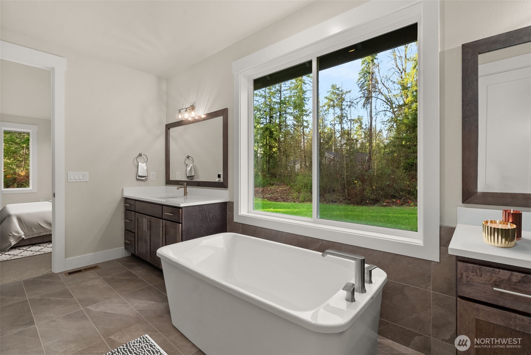 3303 107th Avenue Southwest Olympia, WA 98512 - Photo 18 of 37 a bathroom with a tub a sink a mirror and a window