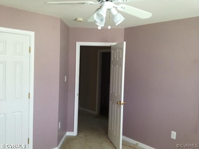 2913 Burley Ridge Terrace Chester, VA 23831 - Photo 8 of 12 a view of a hallway with a chandelier fan and a bathroom