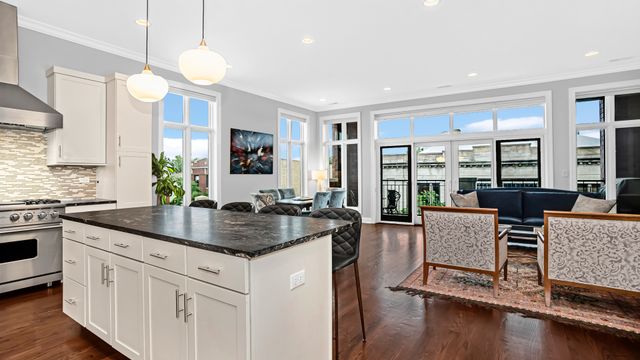 a kitchen with cabinets appliances and a wooden floor