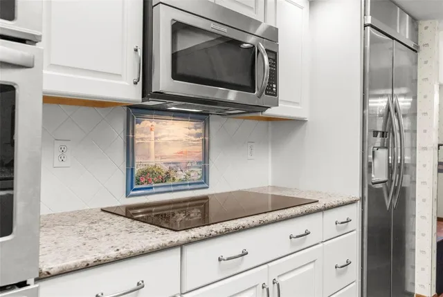 a living room with furniture a rug and a window
