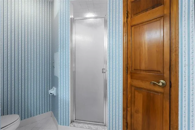 a view of a swimming pool with a yard and glass windows