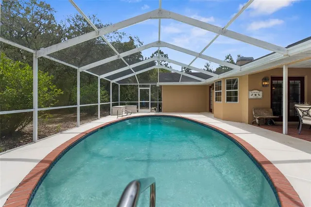 a kitchen with stainless steel appliances granite countertop a sink stove microwave and refrigerator