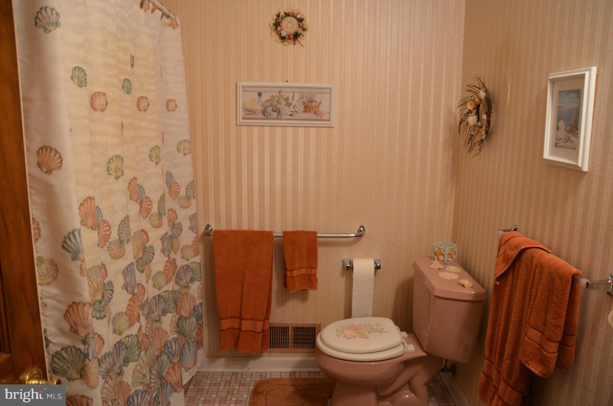 12717 Blair Road Lusby, MD 20657 - Photo 16 of 30 a white toilet sitting next to a bathroom sink