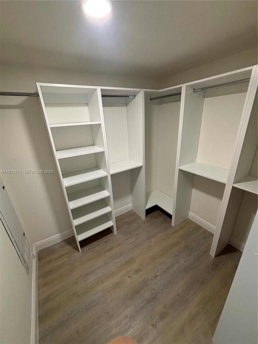 987 Southwest 37th Avenue, Unit 710 Miami, FL 33135 - Photo 3 of 6 a view of walk in closet with empty racks