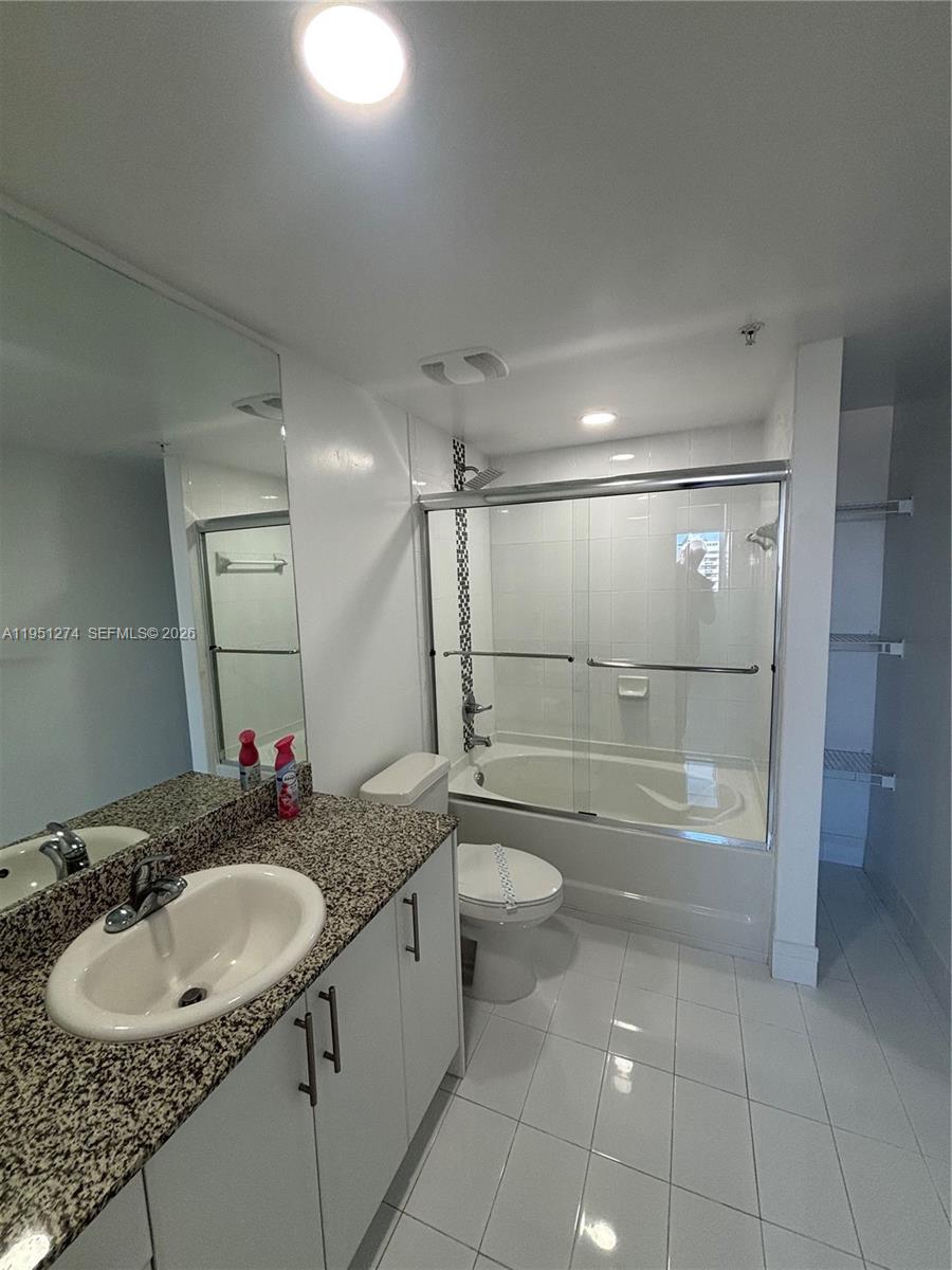 987 Southwest 37th Avenue, Unit 710 Miami, FL 33135 - Photo 6 of 6 a bathroom with a sink toilet and shower