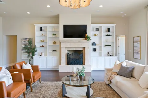 a living room with furniture fireplace and a flat screen tv