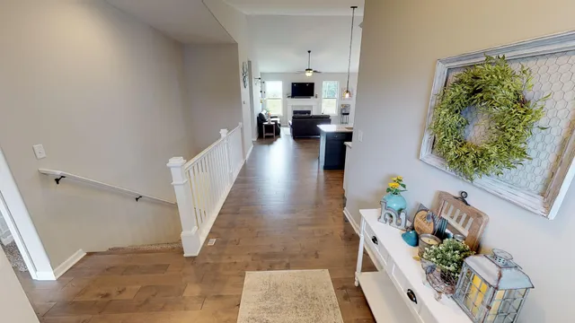 a view of a hallway with wooden floor