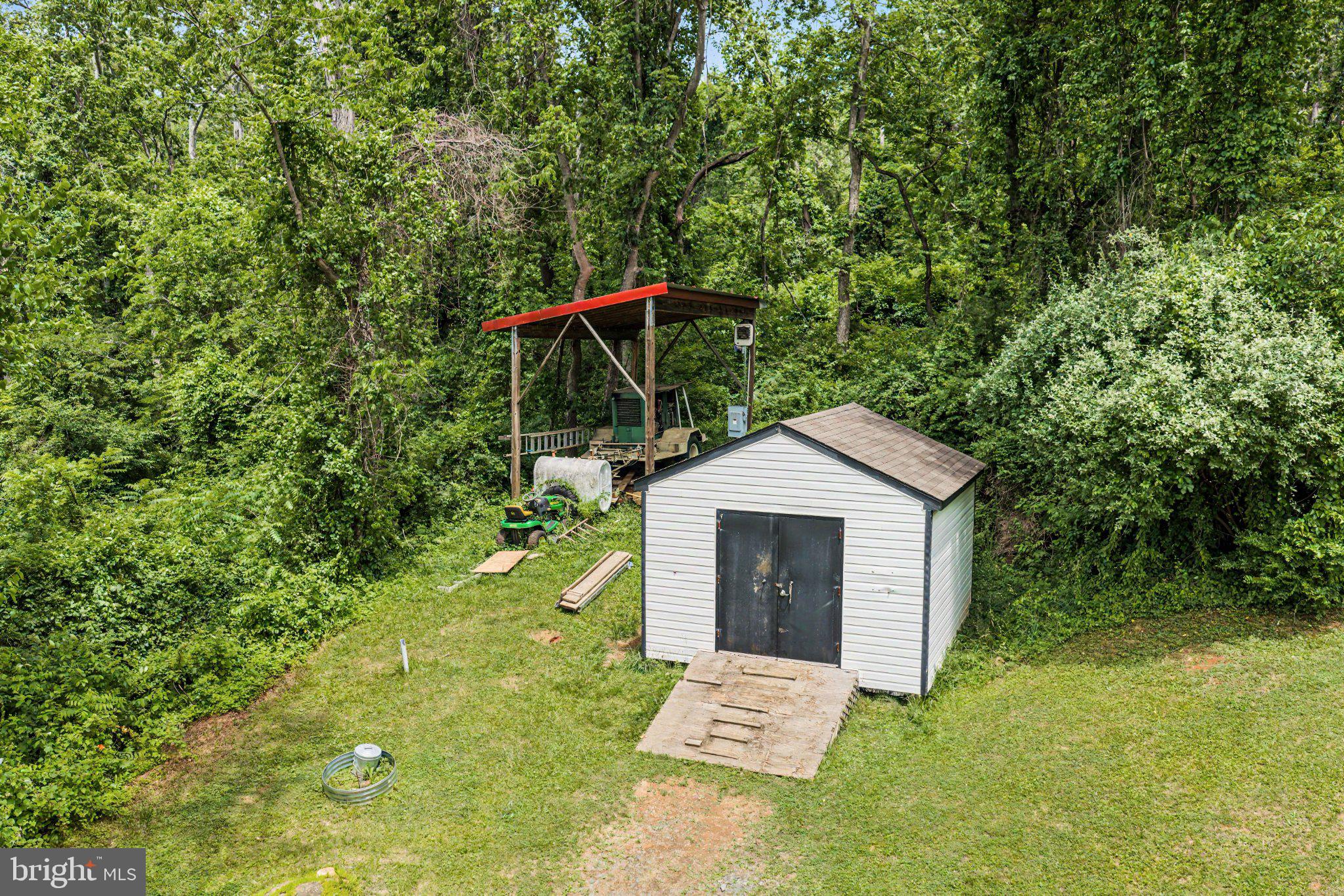 6287 Old Zion Road Warrenton, VA 20187 - Photo 31 of 69 Charming shed nestled in lush greenery.