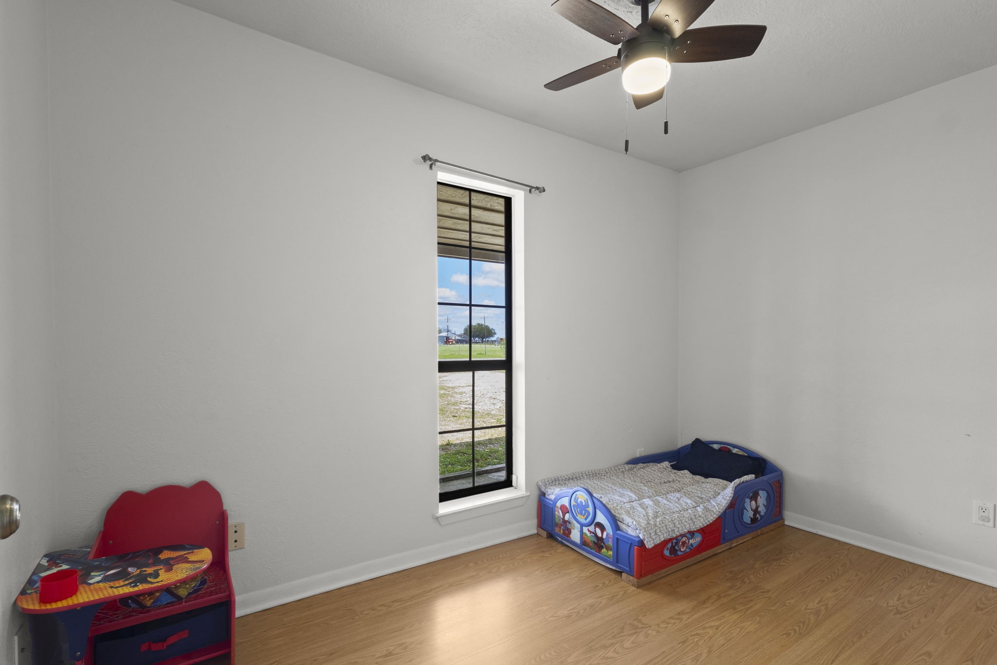 19961 Englin Road Winnie, TX 77665 - Photo 25 of 26 a living room with hard wood floor and a window