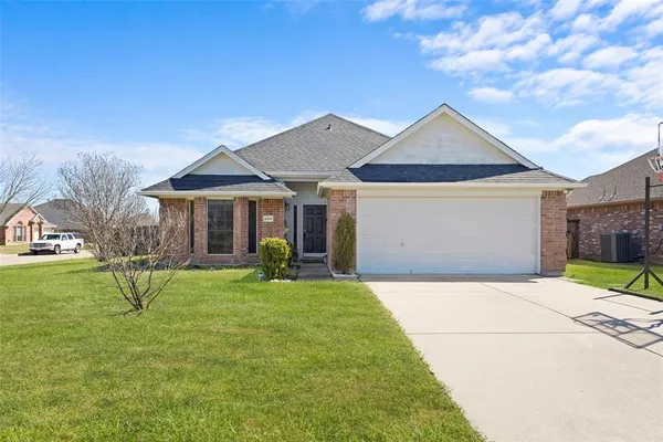 a view of a house with a yard and sitting area