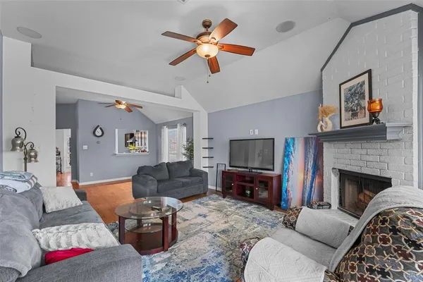 a living room with furniture flat screen tv and a fireplace