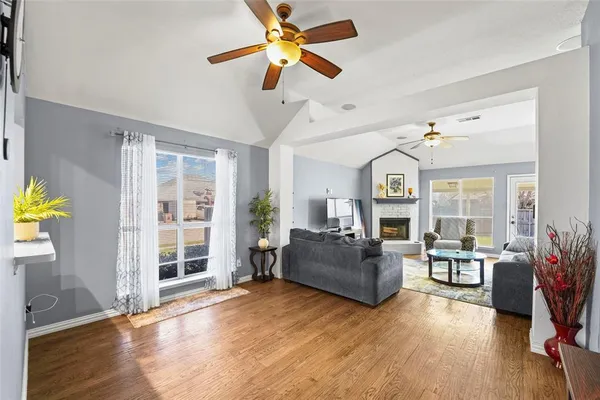 a living room with furniture and wooden floor