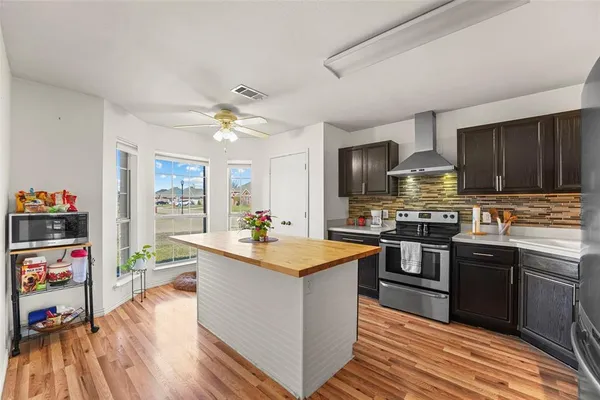 a kitchen with granite countertop a sink stove and cabinets