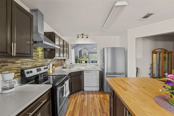 a kitchen with stainless steel appliances a sink stove and refrigerator