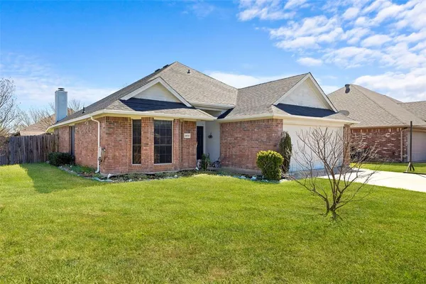 a view of a house with a yard and sitting area