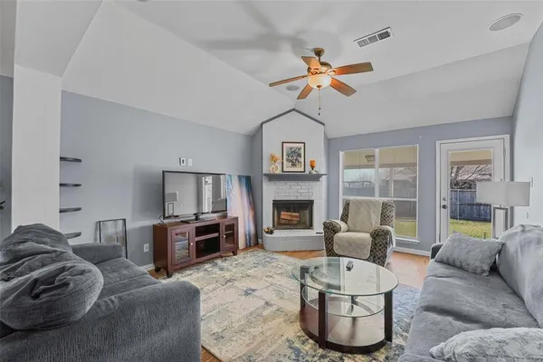 a living room with furniture and a fireplace